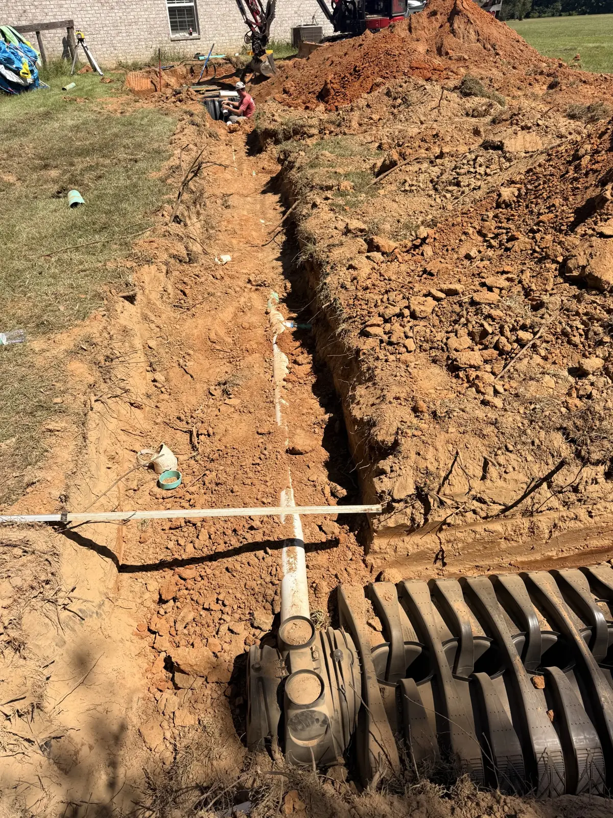 Chamber trench and pipe connection beside a home
