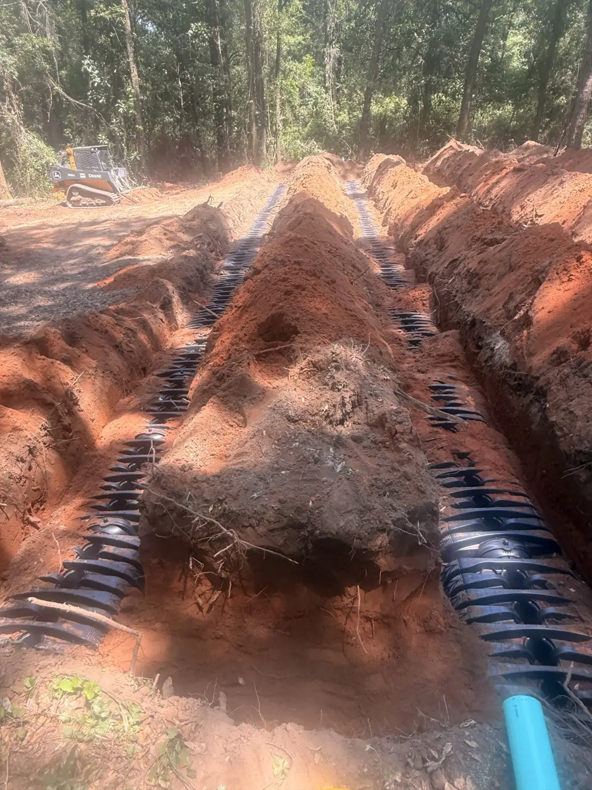 Drain field chambers and blue pipe in a trench