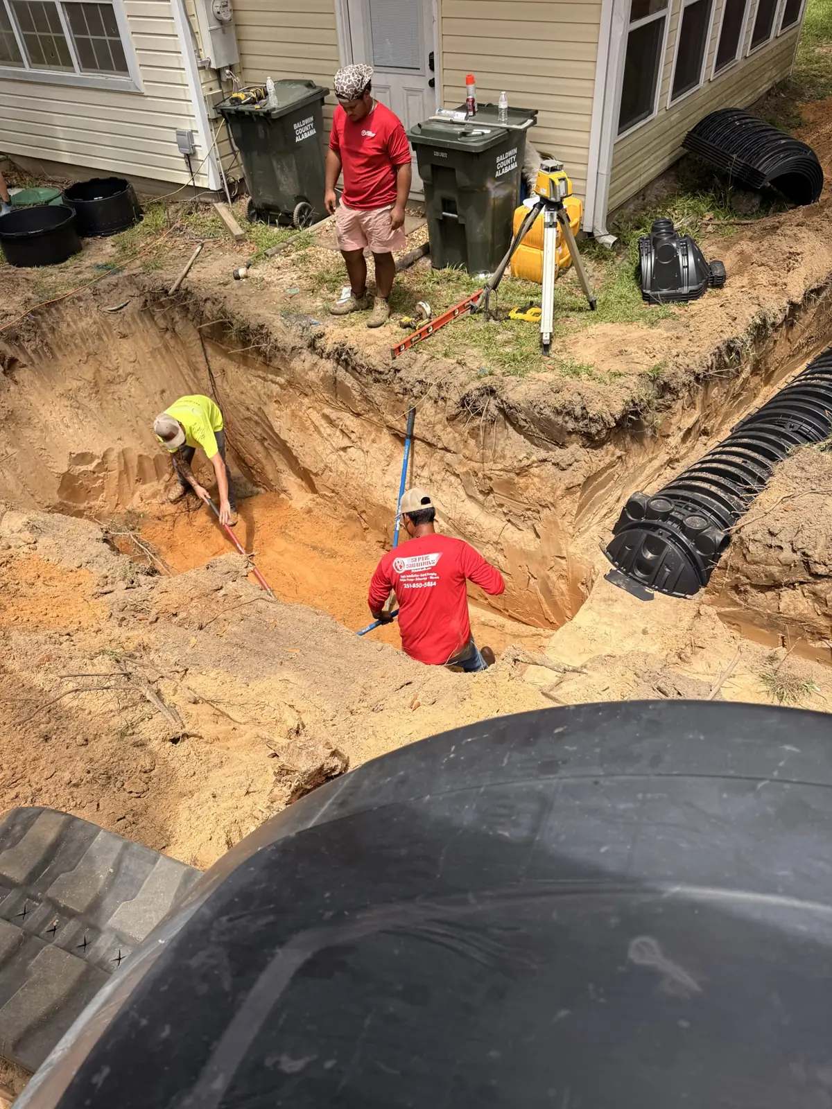 Crew working in an excavation next to a home