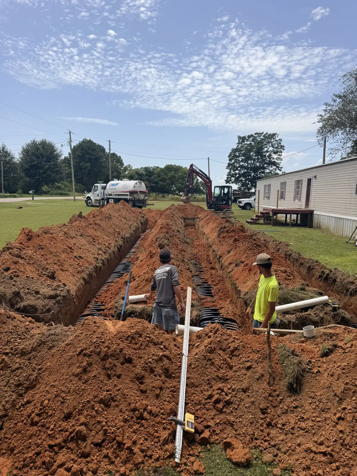 Crew laying field lines across a lot