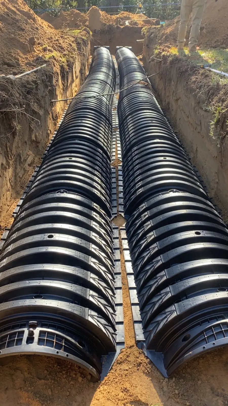 Two rows of drain field chambers laid side by side in a trench
