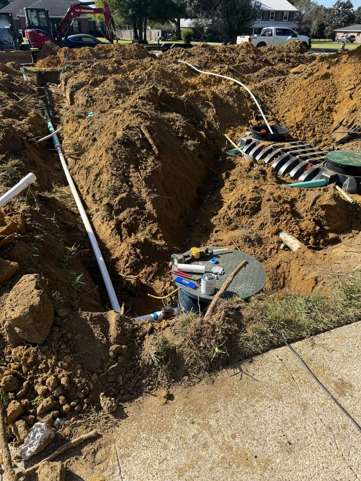Open excavation with septic tank and piping