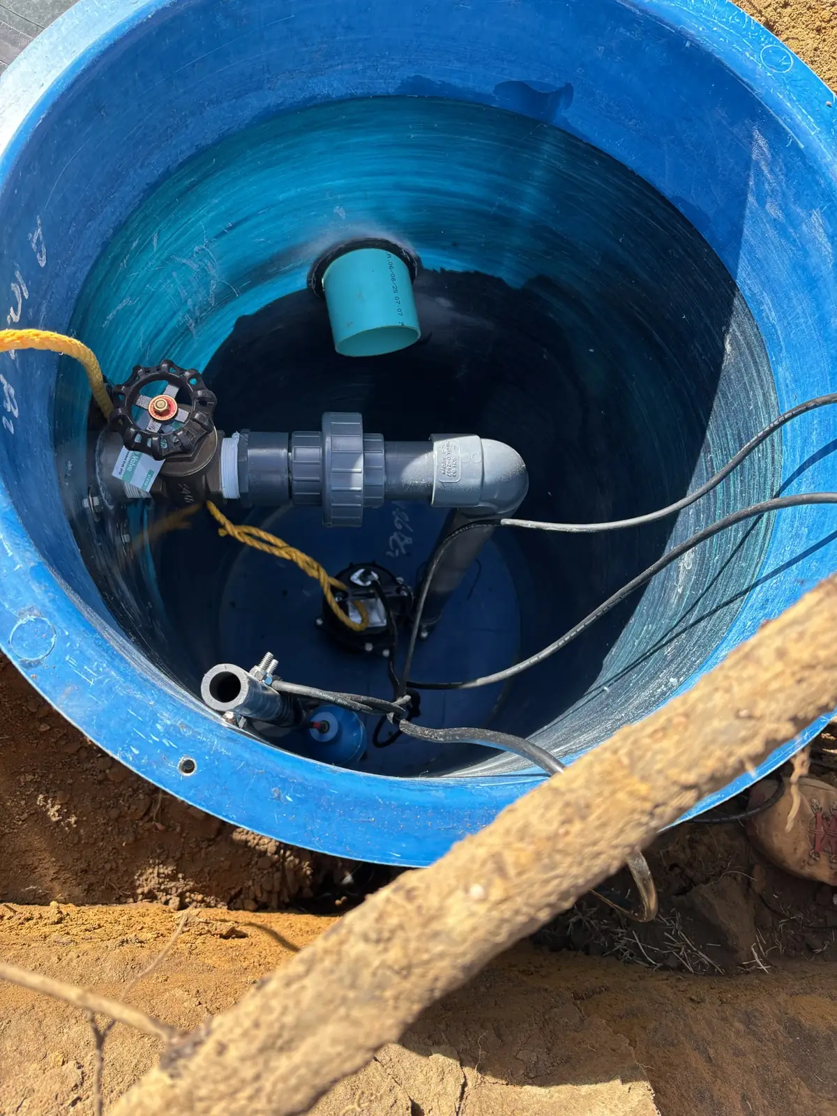 Inside a pump basin showing the pump and discharge piping