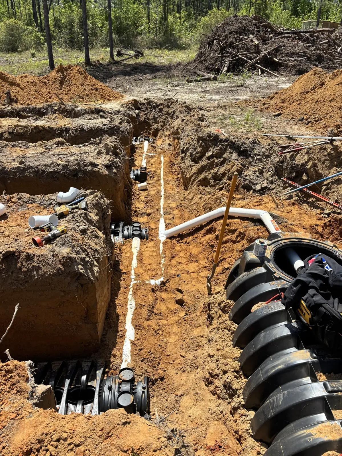 Tank, piping, and chambers in an open trench